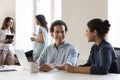 Two happy diverse office colleagues chatting at workplace Royalty Free Stock Photo