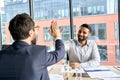 Two happy diverse professional businessmen giving high five at meeting. Royalty Free Stock Photo