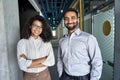 Two happy diverse professional business team people looking at camera in office. Royalty Free Stock Photo