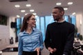 Two happy diverse professional executive business team people woman and African American man walking in coworking office Royalty Free Stock Photo