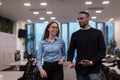 Two happy diverse professional executive business team people woman and African American man walking in coworking office Royalty Free Stock Photo