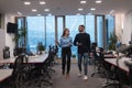 Two happy diverse professional executive business team people woman and African American man walking in coworking office Royalty Free Stock Photo