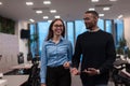 Two happy diverse professional executive business team people woman and African American man walking in coworking office Royalty Free Stock Photo