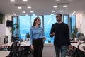 Two happy diverse professional executive business team people woman and African American man walking in coworking office Royalty Free Stock Photo