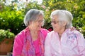 Two happy senior women chatting in garden Royalty Free Stock Photo