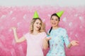 Two happy expressive girls celebrate birthday party with cupcake Royalty Free Stock Photo