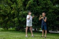 Two happy fair-haired children girl and boy making soap bubbles and playing together in nature outdoors in the park Royalty Free Stock Photo