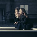 Two happy fashion teen girls on the playground in twilight Royalty Free Stock Photo