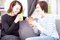 Two happy female friends with coffee cups Royalty Free Stock Photo