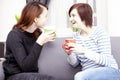 Two happy female friends with coffee cups Royalty Free Stock Photo