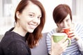 Two happy female friends with coffee cups Royalty Free Stock Photo