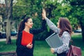 Two happy female friends, students are giving high five after successfully learning Royalty Free Stock Photo