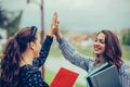 Two happy female students are giving high five after successfully learning Royalty Free Stock Photo