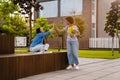 Two happy female students giving high five to each other outdoors in campus Royalty Free Stock Photo