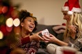 Two happy friends exchanging Christmas gifts Royalty Free Stock Photo