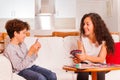 Two happy friends playing cards in the living room Royalty Free Stock Photo