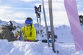 Two happy friends snowboarders and skier are having lunchtime on ski slope in sunny day in the mountains Royalty Free Stock Photo