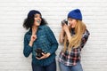 Two happy hipster girls in sunglasses have fun with balloons Royalty Free Stock Photo