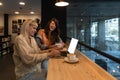 Two happy gen Z student girls watching webinar, attending online class, learning conference, talking to teacher on video call, Royalty Free Stock Photo