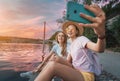 Girl friends taking selfie photo on a bank of Saone river in Lyon Royalty Free Stock Photo