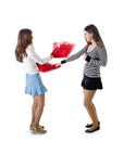 Two happy girlfriends fighting a pillows Royalty Free Stock Photo