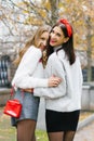 Two happy girlfriends young women embrace, walk through Royalty Free Stock Photo