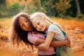 Two happy girls as friends hug each other in cheerful way. Little girlfriends in park. Royalty Free Stock Photo