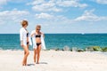 Two happy girls in bikini on the beach. Best friends walking on the beach Royalty Free Stock Photo