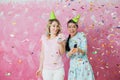 Two happy girls celebrate birthday party with cupcake confetti a Royalty Free Stock Photo