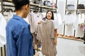 Two happy girls choosing clothes in clothing store Royalty Free Stock Photo