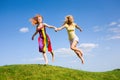Two happy girls fleeing on a meadow. Royalty Free Stock Photo