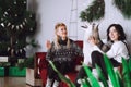 Two happy girls friends or sisters with husky dog in Christmas decorations Royalty Free Stock Photo