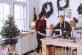 Two happy girls friends or sisters serves the wooden table. Christmas decorations on the kitchen Royalty Free Stock Photo