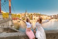 happy girls friends walking on Saint Georges pedestrian bridge while traveling in Lyon old town in France