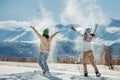 Two happy girls are having fun and tossing snow in mountains Royalty Free Stock Photo