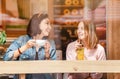 Happy girls having lunch in a cafe, drinking coffe and talking. Friendship and lifestyle concept Royalty Free Stock Photo