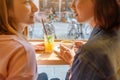 Happy girls having lunch in a cafe, drinking coffe and talking. Friendship and lifestyle concept Royalty Free Stock Photo