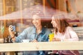 Happy girls having lunch in a cafe, drinking coffe and talking. Friendship and lifestyle concept Royalty Free Stock Photo