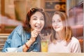 Happy girls having lunch in a cafe, drinking coffe and talking. Friendship and lifestyle concept Royalty Free Stock Photo