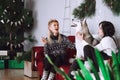 Two happy girls friends or sisters with husky dog in Christmas decorations Royalty Free Stock Photo