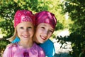 Two happy girls outdoors in kerchiefs on their heads