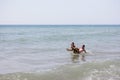 Two girls playing on top of each other on the beach Royalty Free Stock Photo