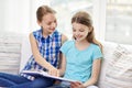 Two happy girls reading book at home Royalty Free Stock Photo