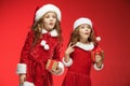 Two happy girls in santa claus hats with gift boxes Royalty Free Stock Photo