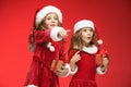 Two happy girls in santa claus hats with gift boxes Royalty Free Stock Photo
