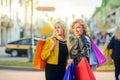 Two girls with shopping bags are standing on the evening street Royalty Free Stock Photo