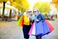 Two happy girls in sunglasses with shopping bags Royalty Free Stock Photo