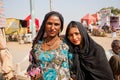 Two happy indian women possing on the village street