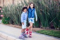 Two happy kids boy and girl roller skate in the park. Children and activity concept Royalty Free Stock Photo