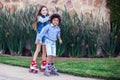 Two happy kids boy and girl roller skate in the park. Children and activity concept Royalty Free Stock Photo